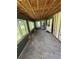 A sun room with bare floors and walls featuring windows and doors, awaiting renovation to become a welcoming space at 34767 Evergreen Way, Ridge Manor, FL 33523