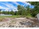 View of the backyard with a concrete slab, offering potential for outdoor living or future construction at 3498 Plaza Ave, Spring Hill, FL 34608