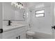 Modern bathroom with white vanity, matte black hardware, and shower over tub at 3498 Plaza Ave, Spring Hill, FL 34608