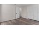 Bedroom featuring wood-look floors and white closet doors at 3498 Plaza Ave, Spring Hill, FL 34608
