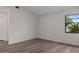 Bright bedroom features wood-look flooring, a closet, and a window providing plenty of natural light at 3498 Plaza Ave, Spring Hill, FL 34608