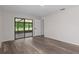 Light filled bedroom with sliding door access to enclosed patio at 3498 Plaza Ave, Spring Hill, FL 34608