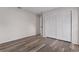 Spacious bedroom featuring modern wood-look floors and closet at 3498 Plaza Ave, Spring Hill, FL 34608