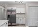 Bright kitchen features white cabinets, quartz counters, stainless appliances, updated lighting and plenty of storage at 3498 Plaza Ave, Spring Hill, FL 34608