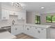 Modern kitchen features white cabinets, quartz counters, stainless appliances, updated lighting and an open floorplan at 3498 Plaza Ave, Spring Hill, FL 34608
