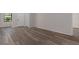 Spacious room with vinyl floors, a white door, and a window for ample natural light at 3498 Plaza Ave, Spring Hill, FL 34608
