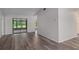Bright, open living room featuring wood-look floors and a large glass sliding door at 3498 Plaza Ave, Spring Hill, FL 34608