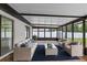 Inviting screened porch with cozy seating, rug, and views of the backyard at 3498 Plaza Ave, Spring Hill, FL 34608