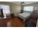 Bedroom with wood floors, two windows, and a metal dog kennel at 4027 31St N Ave, St Petersburg, FL 33713