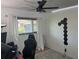 Bright bedroom with a ceiling fan, window, and a gaming chair at 4027 31St N Ave, St Petersburg, FL 33713
