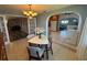 View from dining room into kitchen and another room, featuring a modern light fixture and dining set at 4027 31St N Ave, St Petersburg, FL 33713