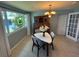 A cozy dining area with a window view, modern chandelier, and dining set at 4027 31St N Ave, St Petersburg, FL 33713