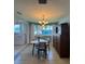 A cozy dining area with a large window view, modern chandelier, dining set and china cabinet at 4027 31St N Ave, St Petersburg, FL 33713
