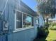 Exterior of the blue home featuring several windows and lawn at 4027 31St N Ave, St Petersburg, FL 33713