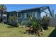 Charming blue home featuring manicured landscaping and a cozy front porch at 4027 31St N Ave, St Petersburg, FL 33713