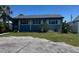 A charming blue single-story home with lush front lawn and mature trees at 4027 31St N Ave, St Petersburg, FL 33713