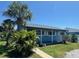 A bright blue single-story home with lush front lawn and a mature palm tree at 4027 31St N Ave, St Petersburg, FL 33713