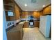 A well-lit kitchen featuring wooden cabinets and modern appliances including a stainless steel refrigerator and oven at 4027 31St N Ave, St Petersburg, FL 33713