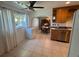 Bright kitchen and breakfast nook area featuring tile floors, a ceiling fan, and a view into the dining room at 4027 31St N Ave, St Petersburg, FL 33713