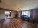 Large living room featuring wood-look floors, a brick fireplace, and view into the dining area at 4027 31St N Ave, St Petersburg, FL 33713