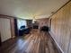 Spacious living room with wood-look floors, brick fireplace, and bright window, perfect for relaxing and entertaining at 4027 31St N Ave, St Petersburg, FL 33713