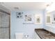 Bright bathroom featuring granite countertop, walk-in shower, and whimsical fish decor at 4452 Garnet Dr # 302, New Port Richey, FL 34652