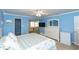 Bright blue bedroom featuring plush carpet, walk-in closet, and ample natural light at 4452 Garnet Dr # 302, New Port Richey, FL 34652