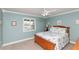 Cozy bedroom with light walls, ceiling fan, and window letting in natural light at 4452 Garnet Dr # 302, New Port Richey, FL 34652