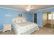 Comfortable bedroom features a walk-in closet, plush carpet, and serene blue walls at 4452 Garnet Dr # 302, New Port Richey, FL 34652