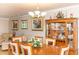 Cozy dining room with wood table set, and china cabinet open to the living room at 4452 Garnet Dr # 302, New Port Richey, FL 34652