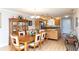 Open floor plan of dining room flowing into the kitchen with island and stainless appliances at 4452 Garnet Dr # 302, New Port Richey, FL 34652