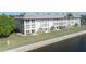 Waterfront condo building boasts well-maintained lawn and patio areas perfect for relaxation at 4452 Garnet Dr # 302, New Port Richey, FL 34652