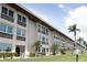 Exterior of condo building featuring large windows and manicured landscaping at 4452 Garnet Dr # 302, New Port Richey, FL 34652