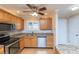 Bright kitchen with stainless steel appliances, stone countertops, and wood cabinets at 4452 Garnet Dr # 302, New Port Richey, FL 34652