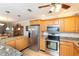 Bright kitchen features stainless steel appliances, granite counters and wood floors at 4452 Garnet Dr # 302, New Port Richey, FL 34652