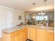 Open kitchen with granite counters and wood cabinets that flows into the dining and living areas at 4452 Garnet Dr # 302, New Port Richey, FL 34652
