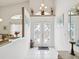 Bright foyer featuring decorative glass doors and tile flooring at 489 Tournament Dr, Spring Hill, FL 34608