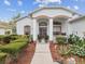 Welcoming front entrance with colorful plants and manicured landscaping at 489 Tournament Dr, Spring Hill, FL 34608