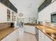 Bright kitchen featuring white cabinets, stone countertops, and stainless steel appliances at 489 Tournament Dr, Spring Hill, FL 34608