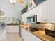 Kitchen with white cabinets, stainless steel appliances, stone backsplash, and granite countertops at 489 Tournament Dr, Spring Hill, FL 34608