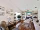 Bright living room featuring a fireplace, hardwood floors, and comfortable seating at 489 Tournament Dr, Spring Hill, FL 34608