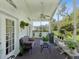 Relaxing screened-in patio with comfortable seating, decorative plants and a grill at 489 Tournament Dr, Spring Hill, FL 34608