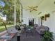 Relaxing screened-in patio with comfortable seating, decorative plants and a grill at 489 Tournament Dr, Spring Hill, FL 34608