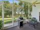 This patio features decorative plants, a grill, and a view of the lush green yard at 489 Tournament Dr, Spring Hill, FL 34608