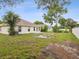 Spacious backyard featuring a large grassy area and a concrete patio, perfect for outdoor enjoyment at 5048 Teather St, Spring Hill, FL 34608