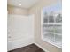 Bathroom highlighting the tub and shower with a window that provides natural light and ventilation at 5048 Teather St, Spring Hill, FL 34608