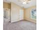Bright bedroom featuring neutral walls, carpet, ceiling fan and an exterior view at 5048 Teather St, Spring Hill, FL 34608