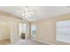 An airy bedroom features a fan, closet, and natural light, creating a cozy retreat at 5048 Teather St, Spring Hill, FL 34608