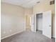 Neutral bedroom with an open closet, neutral carpet and a partial view to the next room at 5048 Teather St, Spring Hill, FL 34608