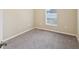 Bedroom featuring carpet, neutral walls, and a window with natural light at 5048 Teather St, Spring Hill, FL 34608